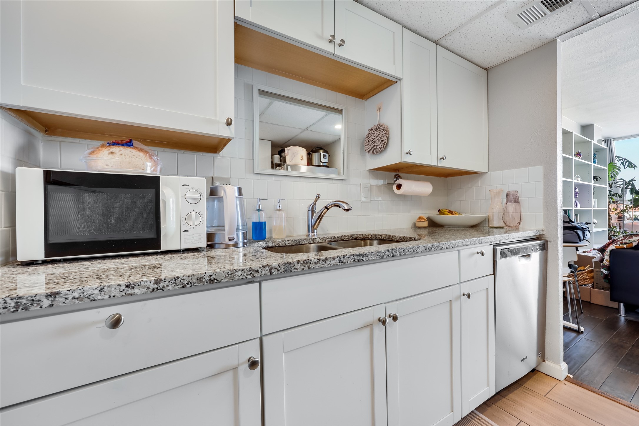 1800 Lavaca Street, Unit A711 Austin, TX 78701 - Photo 7 of 18 a kitchen with granite countertop white cabinets and white appliances