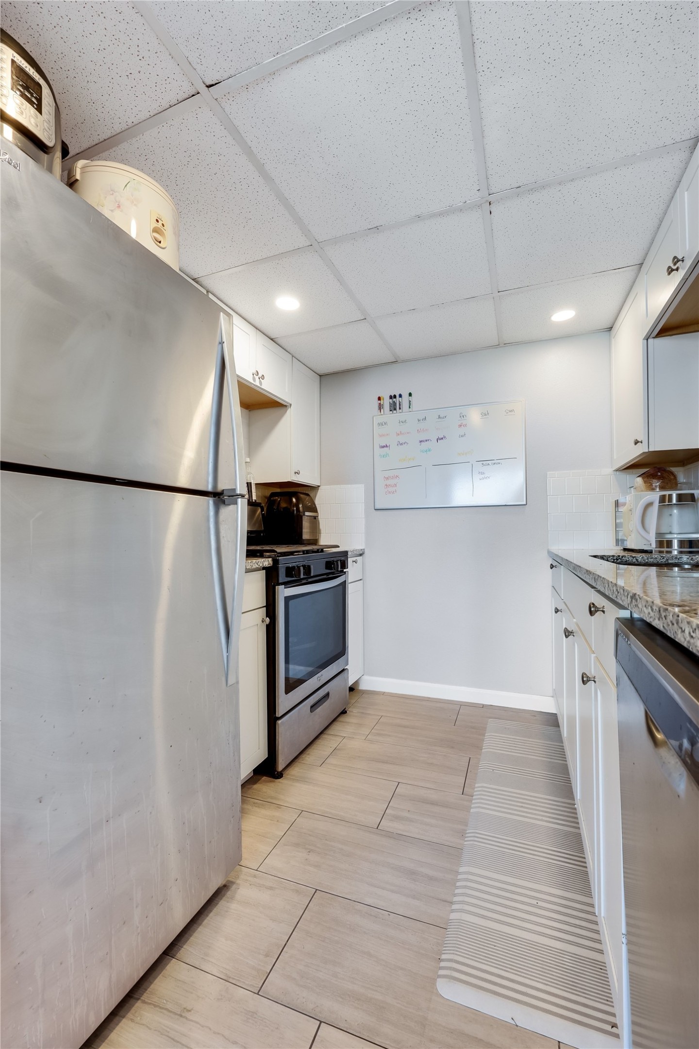 1800 Lavaca Street, Unit A711 Austin, TX 78701 - Photo 8 of 18 a kitchen with stainless steel appliances a refrigerator sink and cabinets