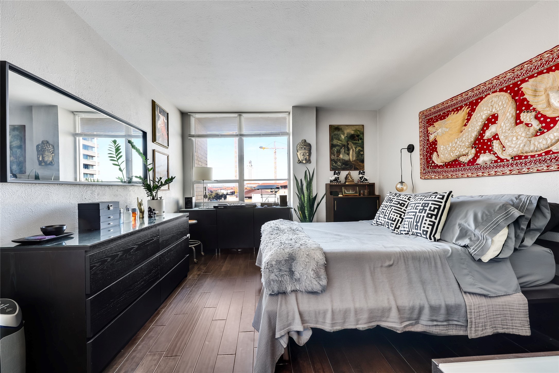 1800 Lavaca Street, Unit A711 Austin, TX 78701 - Photo 10 of 18 a bedroom with a bed and wooden floor