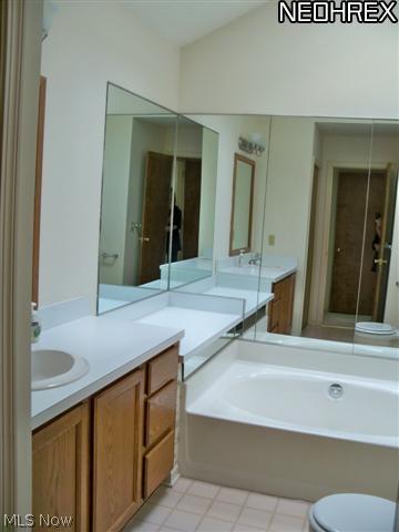1938 Lillian Road Stow, OH 44224 - Photo 12 of 22 Huge master bath with garden tub, neutral flooring and new vanity lights.