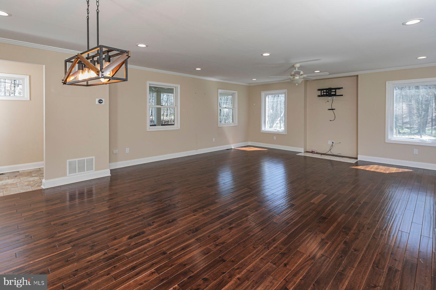 310 Hollow Road Skillman, NJ 08558 - Photo 7 of 32 a view of an empty room with wooden floor and a window