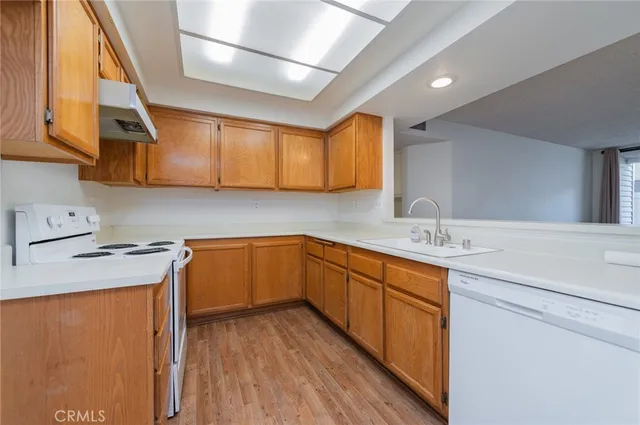 a kitchen with sink cabinets and wooden floor
