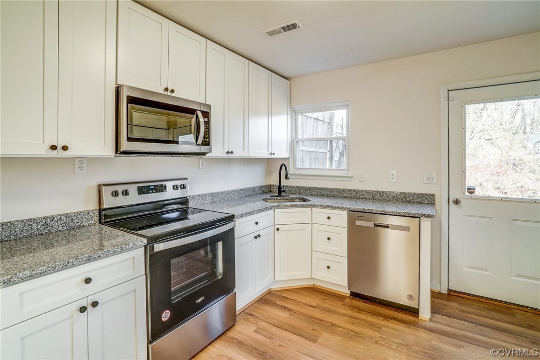 603 Bailey Road Charlottesville, VA 22903 - Photo 18 of 37 a kitchen with stainless steel appliances granite countertop white cabinets granite counter tops and a wooden floors