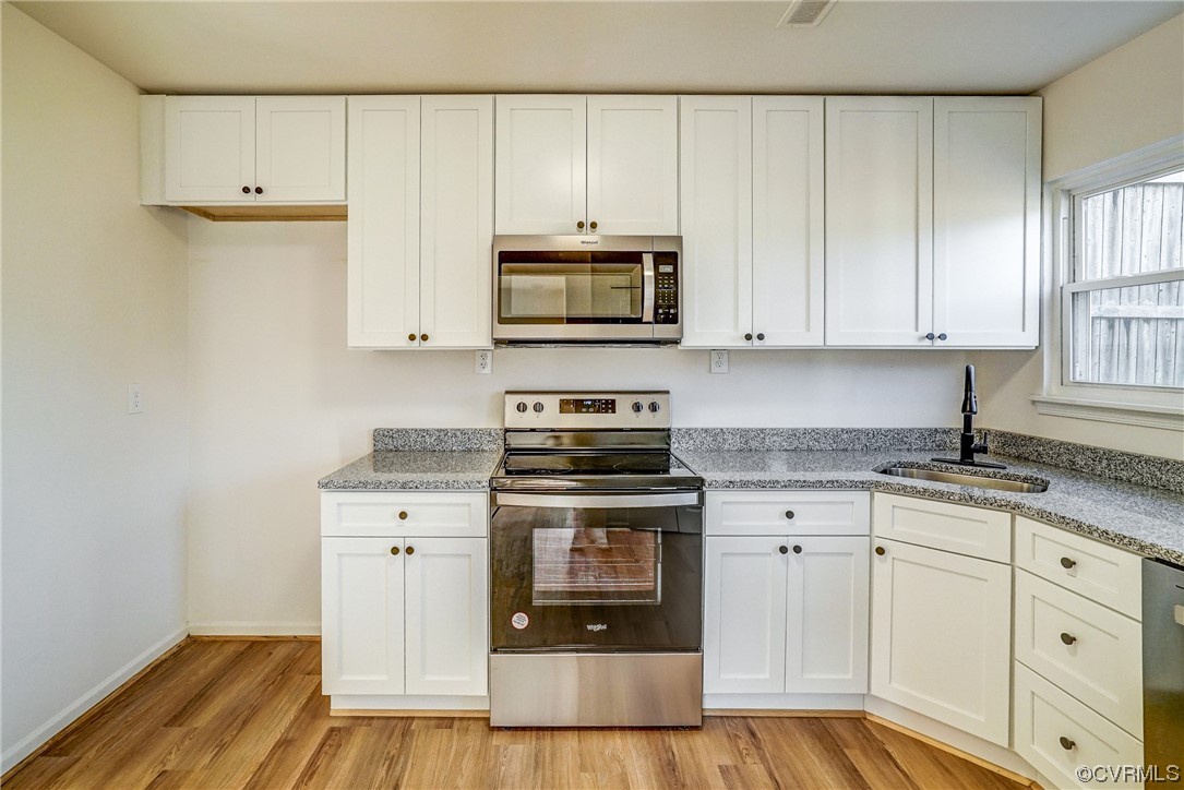 603 Bailey Road Charlottesville, VA 22903 - Photo 19 of 37 a kitchen with granite countertop a stove a sink and a microwave