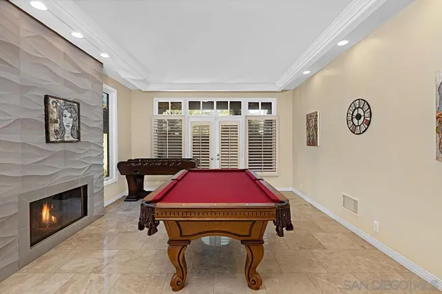 a view of a dining room with furniture and floor to ceiling window