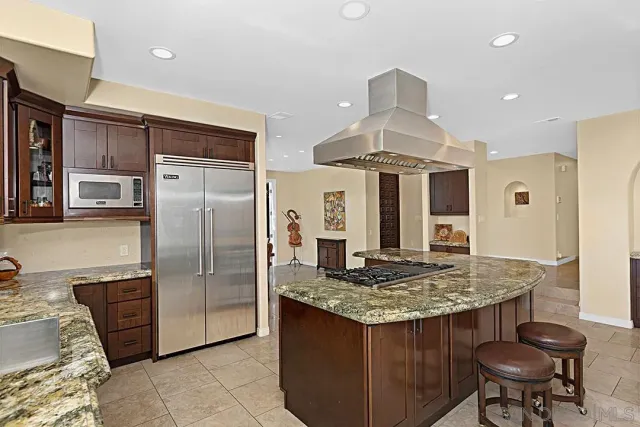 a living room with furniture a large window and a fireplace