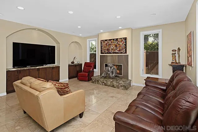 a living room with furniture and a view of kitchen