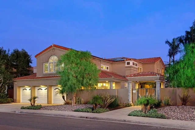 a front view of house with a garden