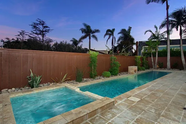 a backyard of a house with plants and outdoor seating