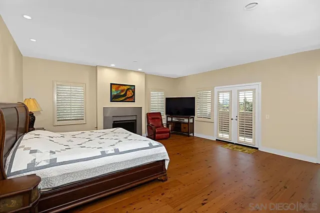 a view of a hallway with wooden floor and a living room
