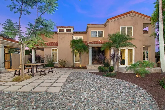 a wooden bench sitting in front of a house