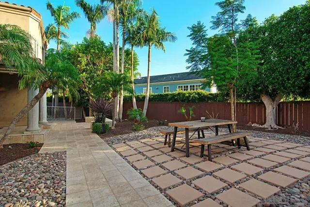 a view of a house with backyard and sitting area