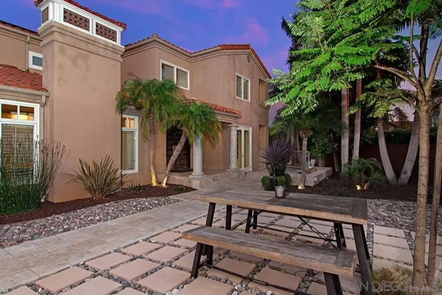 a view of a patio with table and chairs and potted plants