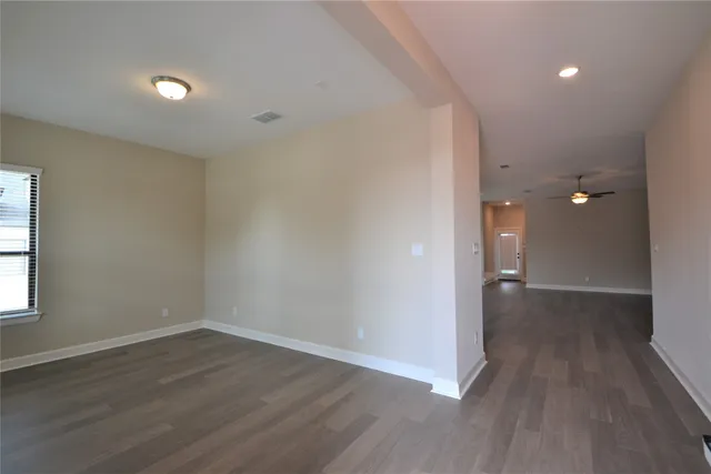 a spacious bathroom with a tub double sink and mirror