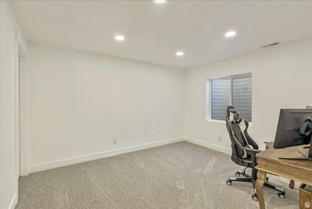 3916 South Sage Wood Avenue Mapleton, UT 84664 - Photo 28 of 33 Bright room featuring light-toned carpeting, crisp white walls, recessed ceiling lighting, a white-framed window, and a white baseboard trim