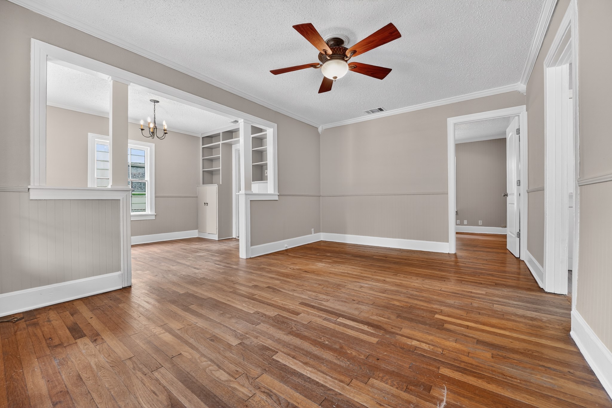 4907 Duval Street Austin, TX 78751 - Photo 5 of 31 an empty room with wooden floor and windows