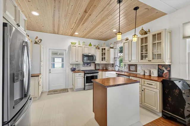 a kitchen with granite countertop a sink appliances cabinets and counter space