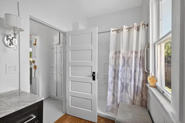 a bathroom with a shower and a tub