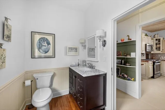 a bathroom with a toilet sink and mirror