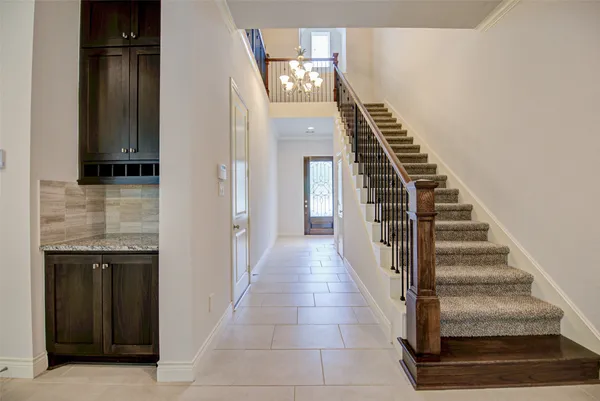 a view of a hallway with wooden floor and entryway