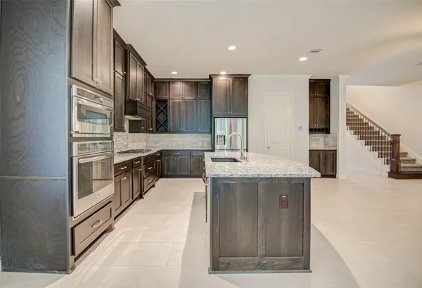 a kitchen with stainless steel appliances granite countertop a lot of counter top space