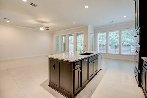 a kitchen with granite countertop a stove and a sink