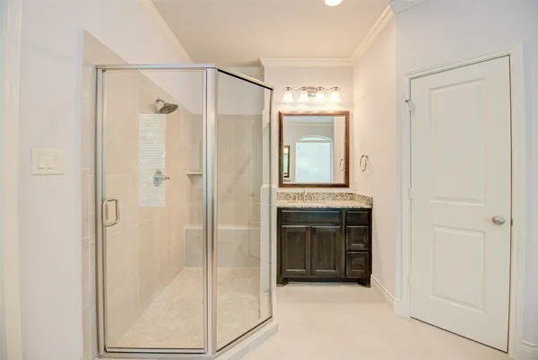 a bathroom with a shower and a sink