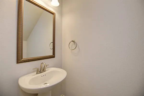 a bathroom with a sink and mirror