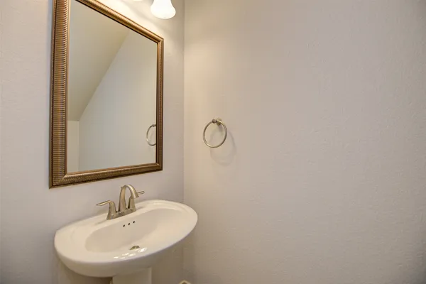 a bathroom with a sink and mirror