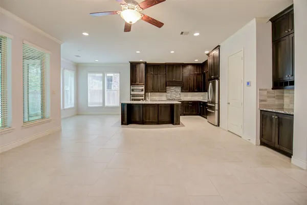 a large white kitchen with a stove and a refrigerator