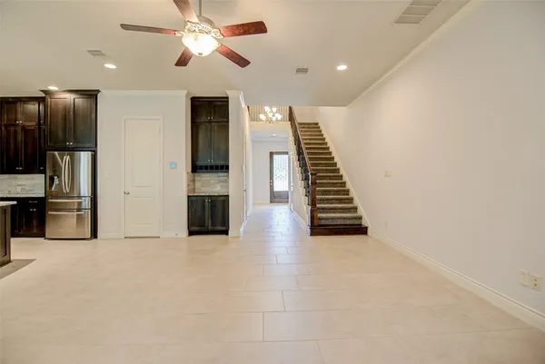 a view of a kitchen with an empty space and a ceiling fan