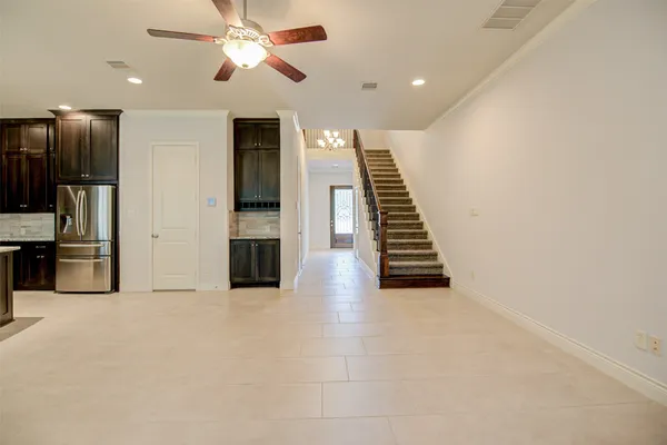 a view of a kitchen with an empty space and a ceiling fan