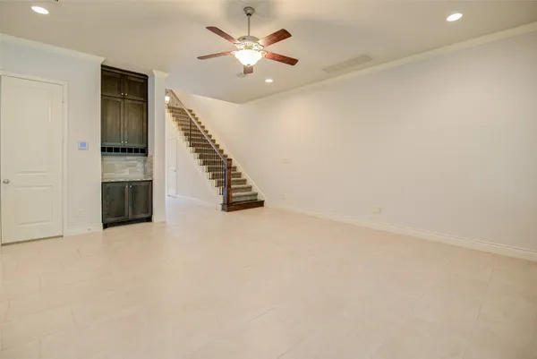 an empty room with a ceiling fan and a window