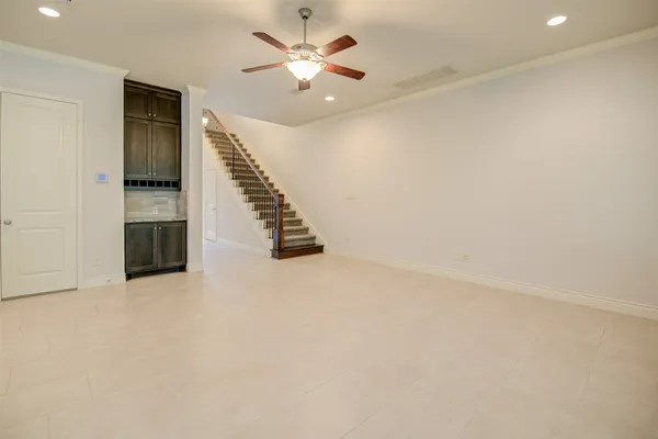 an empty room with a ceiling fan and a window