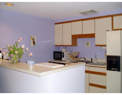 28 Parkman Street, Unit 2 Brookline, MA 02446 - Photo 6 of 8 a kitchen with stainless steel appliances a sink a stove a refrigerator a counter top space and cabinets