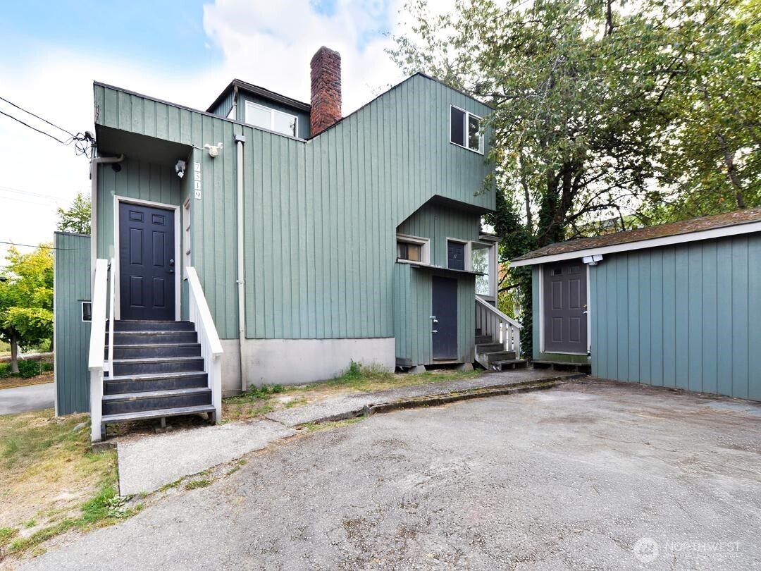 7519 Greenwood Avenue North, Unit 1 Seattle, WA 98103 - Photo 2 of 13 a view of a house with backyard and trees