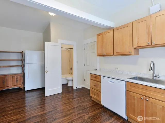 a kitchen with stainless steel appliances granite countertop a refrigerator sink and cabinets