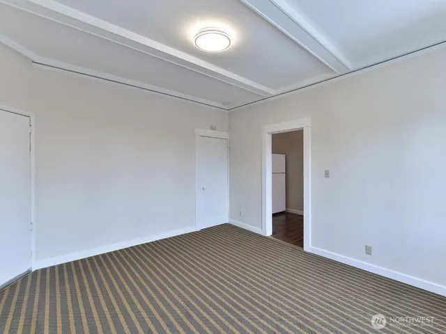 a view of an empty room with wooden floor