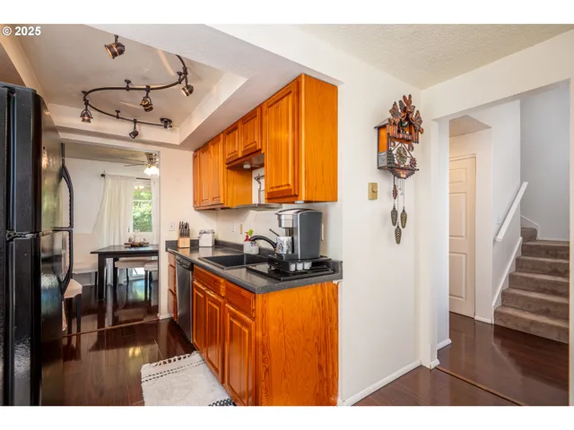 a kitchen with stainless steel appliances a stove a refrigerator and a microwave