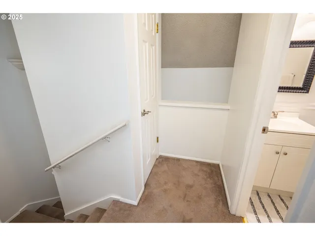 a view of closet with wooden floor