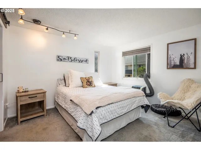 a bedroom with a bed a chair and a couch