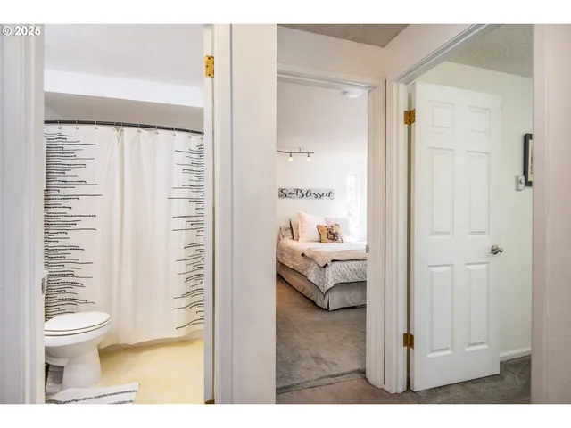 a bathroom with a toilet and a shower curtain