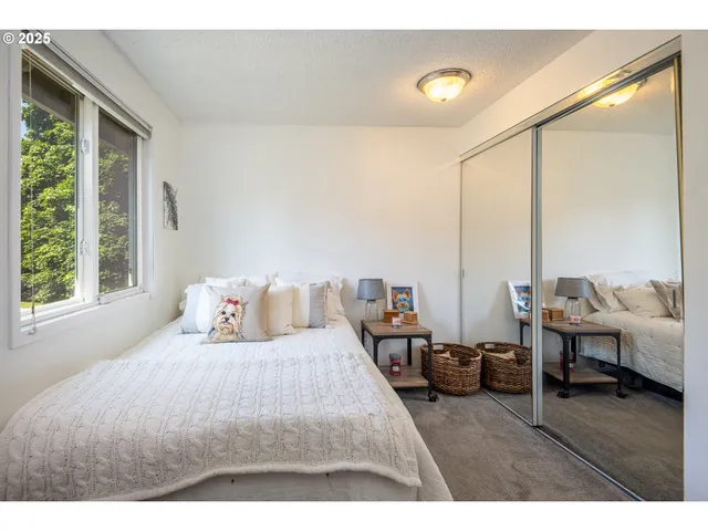 a bedroom with furniture and a large window