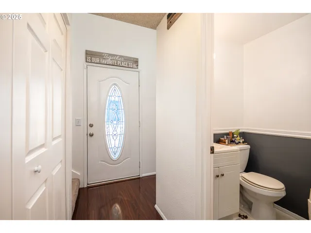 a bathroom with a toilet a sink and a mirror