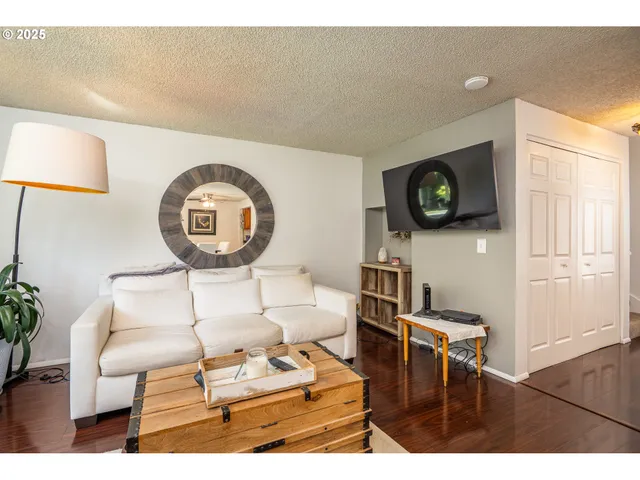 a living room with furniture a rug and a window