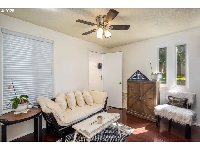 a living room with furniture and a potted plant