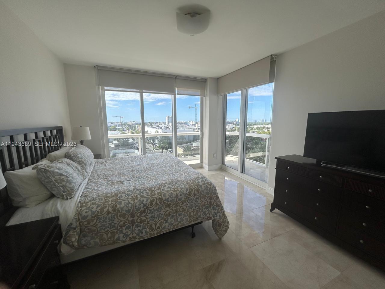 9595 Collins Avenue, Unit N8H Surfside, FL 33154 - Photo 8 of 35 a bedroom with a bed and large window