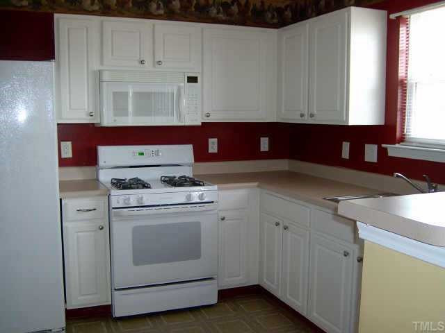 great kitchen with lots of cabinets and eat-on bar Other