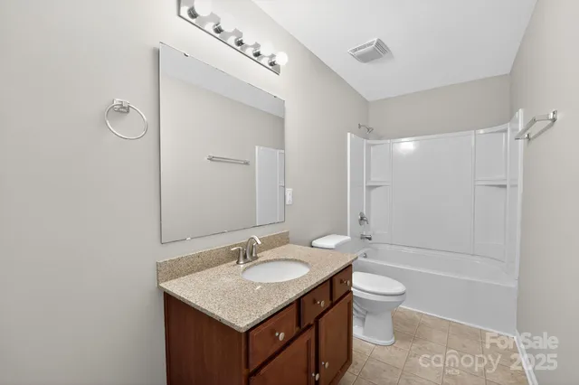 a bathroom with a sink toilet tub and shower