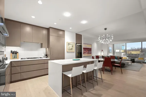 a large kitchen with a table and chairs